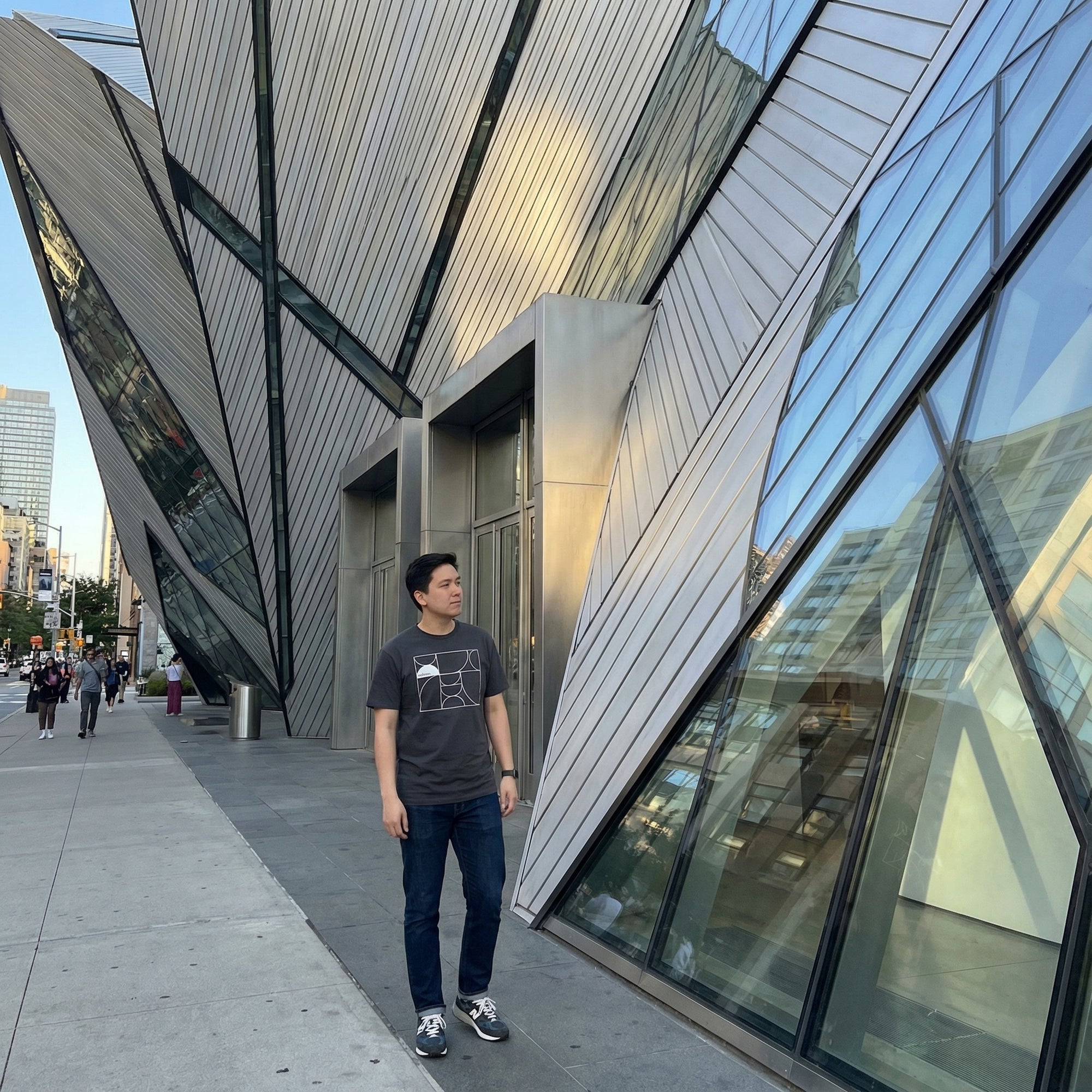 Man standing in front of a modern architectural building with geometric design
